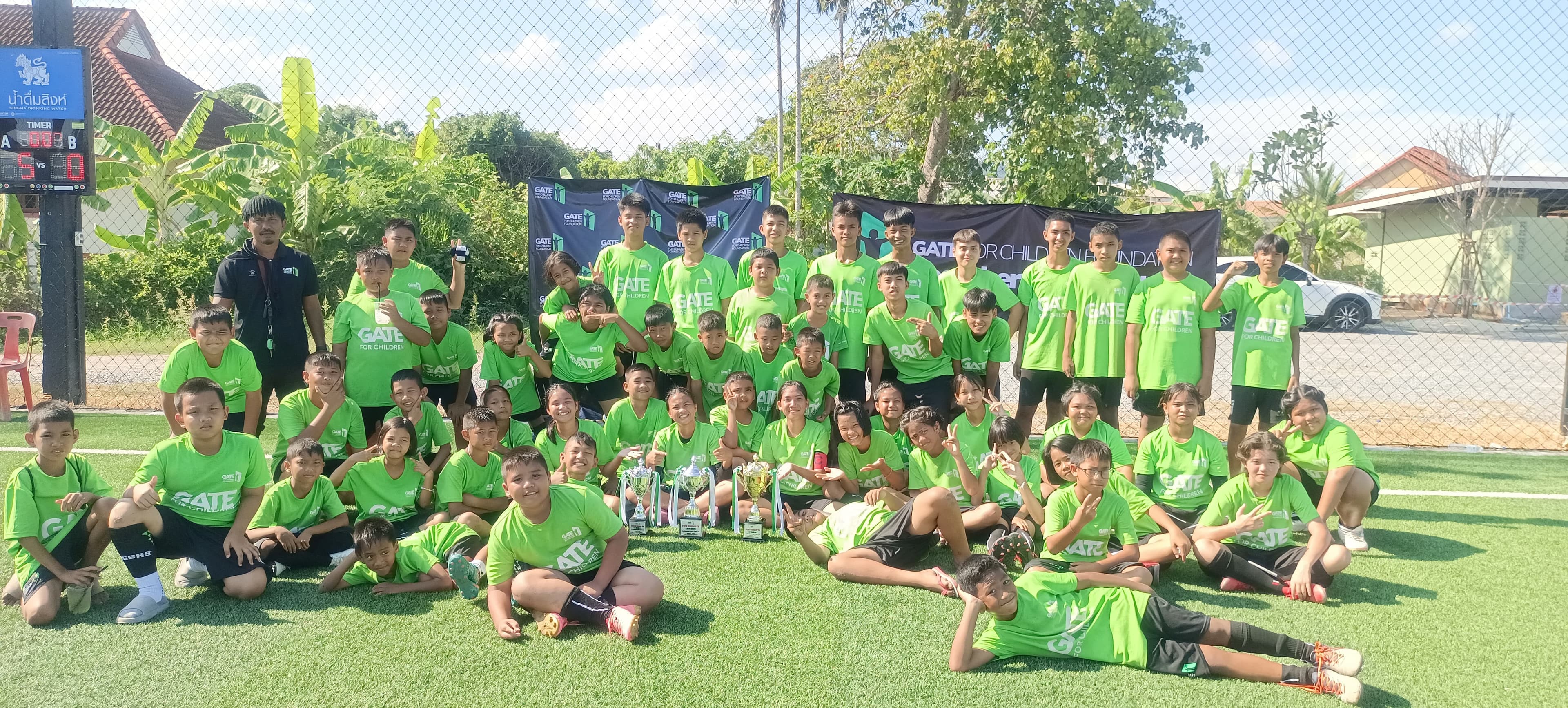The Bridge for Future community celebrating together with trophies